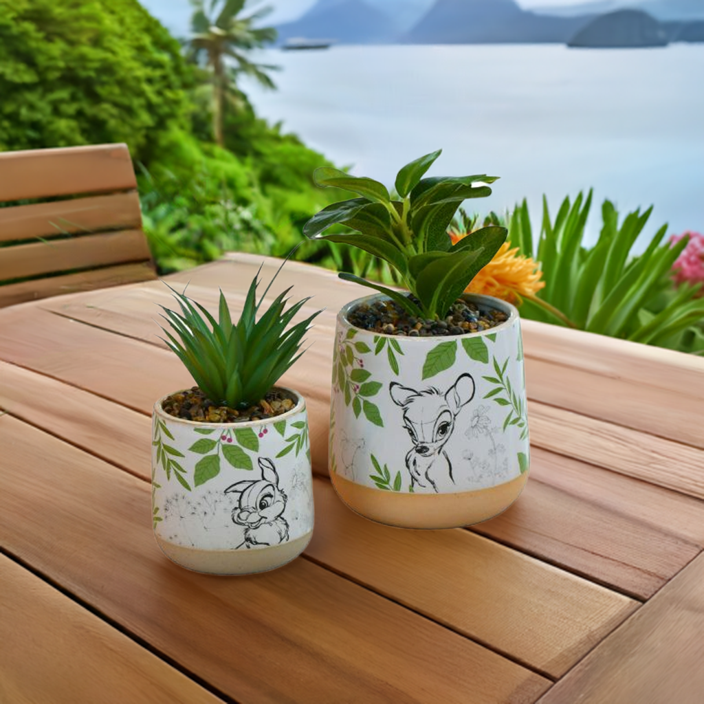 Bambi og trampe potteplantesett ute på hytta med utsikt mot havet. Nydelig sett med en stor og en liten blomsterpotte med blomster i. Nydelige tegne illustrasjoner fra disney filmen bambi og grønne blader.