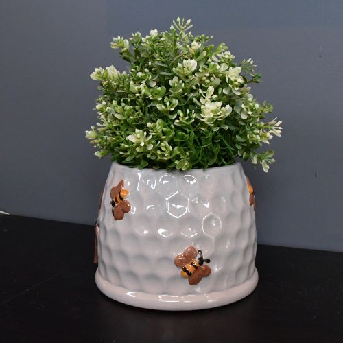Krukke med bier på med blomst oppi