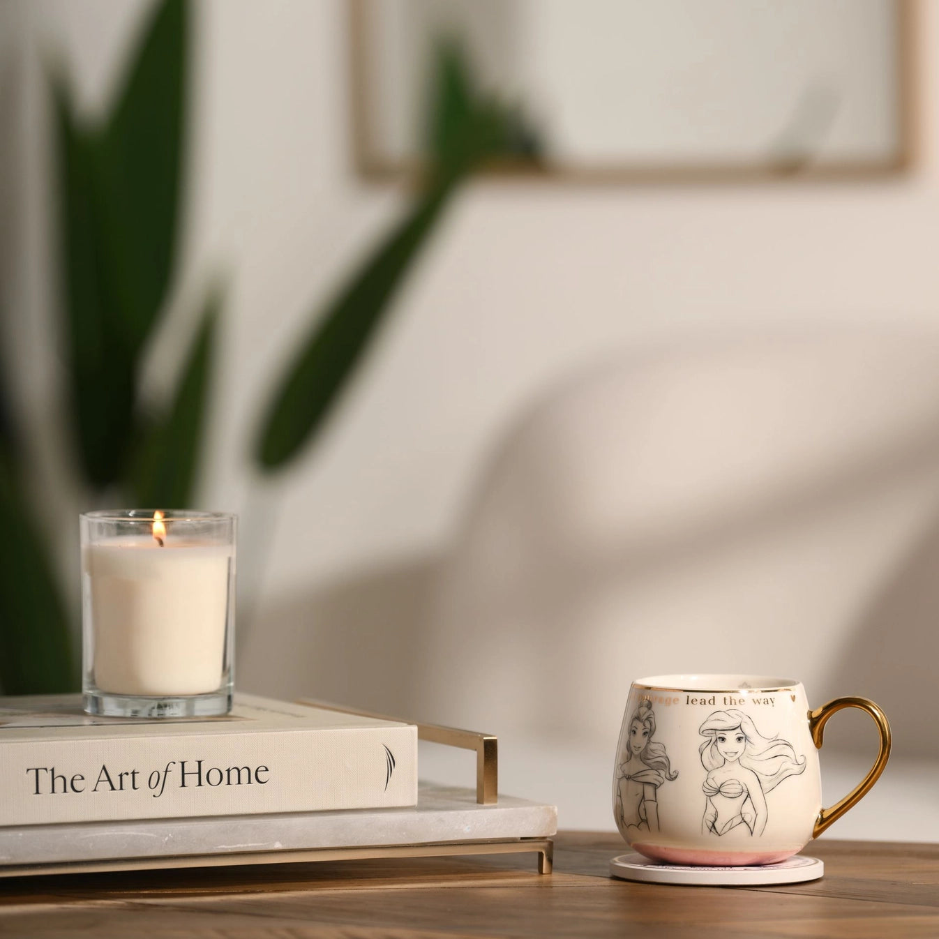 Disney prinsesse samle krus med nydelige gulldetaljer i bruk. Rosa bunn på koppen. Håndtegnede illustrasjoner av prinsessene Belle, Ariel, Jasmine, Cinderella og Snehvit og med teksten “Let courage lead the way. Disney magi i hverdagen.