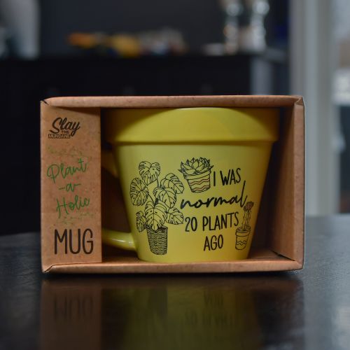 Gul plante kopp med humor. På kruset står det "I was normal 20 plants ago"