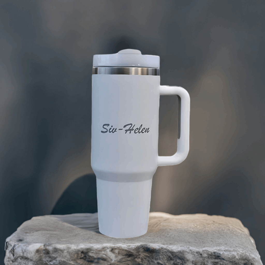 Hvit termokopp med lasergravering utstilt på en stein. Perfekt til både kald og varm drikke.
