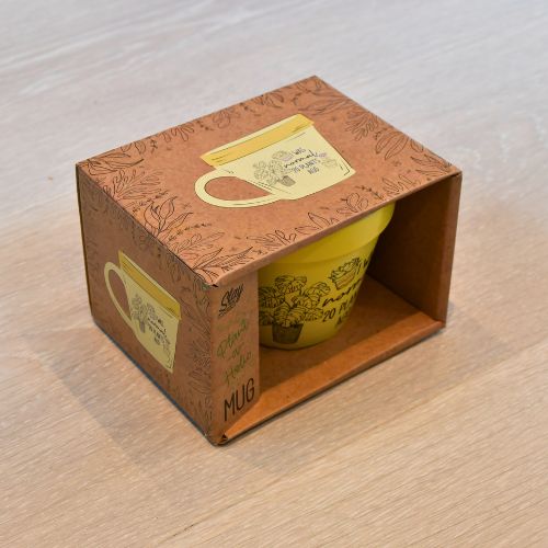 Esken til den gule plante koppen er veldig fin med bilder av koppen og tekst.