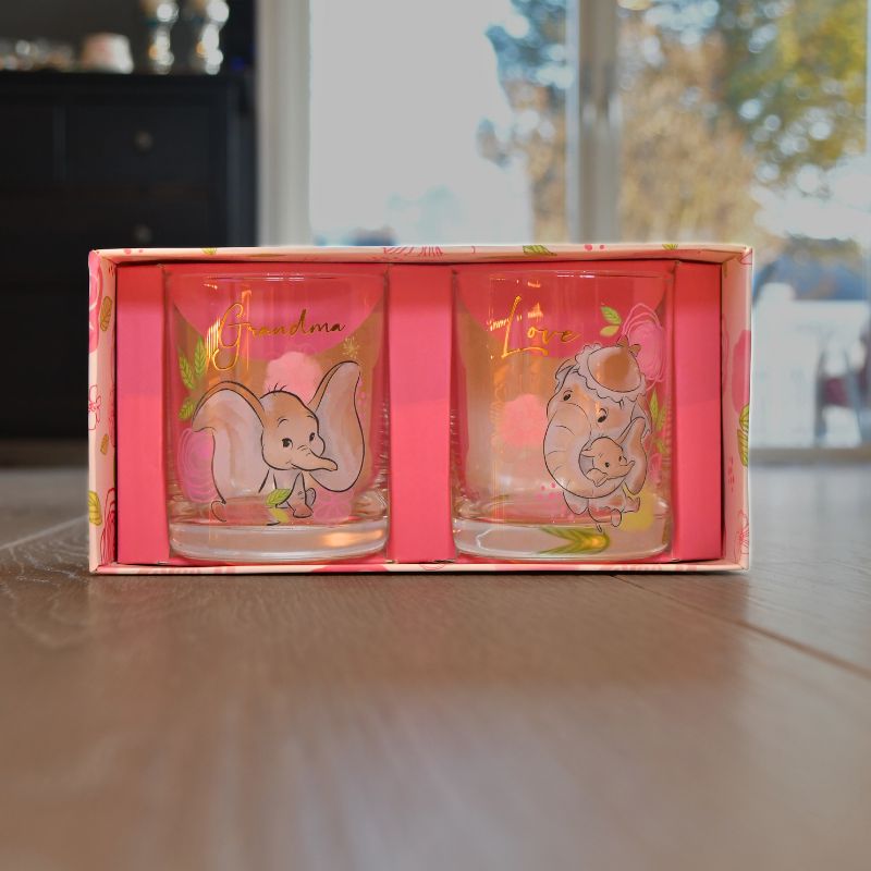 Her er begge glassene i den nydelige esken sin. Det er bilde av dumbo på begge glassene. 