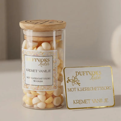 Duftoks kuler med lukten av kremet vanilje. Duftvoks kulene fyller huset med en søt og deilig lukt ved å smelte noen kuler i duftvoks brenneren din. Disse kulene er i fargen kremhvit og gul og vi håper de kan hjelpe noen med kjærlighetssorg i en vanskelig periode. Det følger derfor med duftvokskort med noen ord om kjærlighetssorg. 