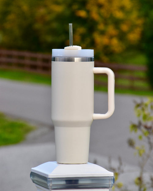 tumbler med håndtak og sugerør i beige farge. 1,2 liter med drikke igjennom dagen. Holder drikken kald eller varm. Lasergravering om ønskelig. Silikongrep. Designet i Norge. Personlig gave med laser gravert tekst om man ønsker. 