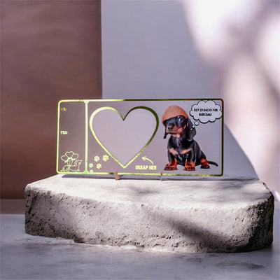 Nydelig skrape bursdagskort med dachs hund som har en tenke boble over seg hvor det står "det er dachs for bursdag". Kortet har også en liten gullfoliert dachshund med hjerteballonger og noen fotspor fra en hund på seg. Det følger med et hjerte skrape klistremerke som man kan feste over det store hjertet på kortet når man har skrevet overraskelsen inni feltet, sånn at den som får kortet må skrape fram beskjeden. En unik og morsom måte å gi bort en bursdagsgave på. 
