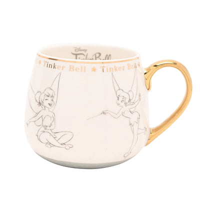 Tingeling Disney-krus i bone china med gullkanter, frontvisning. Start dagen med tingeling kaffe krus fra Disneys samle krus serie. Tingeling fra Peter Pan er illustrert med tegninger rundt telekoppen. Håndtaket er i gull som gir den et luksuriøst utrykk samtidig som disney karakteren tingeling gir nostalgi.