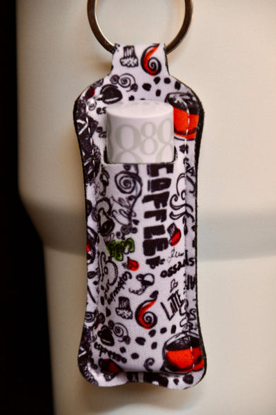 En veske med kaffe motiv. Designet til lipsyl eller leppestift, som er festet på en termokopp med kult design. For kaffe elskere. Lett tilgjengelig. 